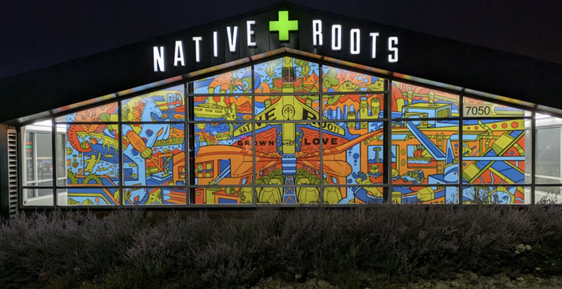 The lights of the Native Roots dispensary on Tower Road illuminate local artist Joe Palec's newest mural.