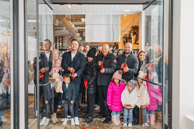 Image: a group of people at a ribbon cutting