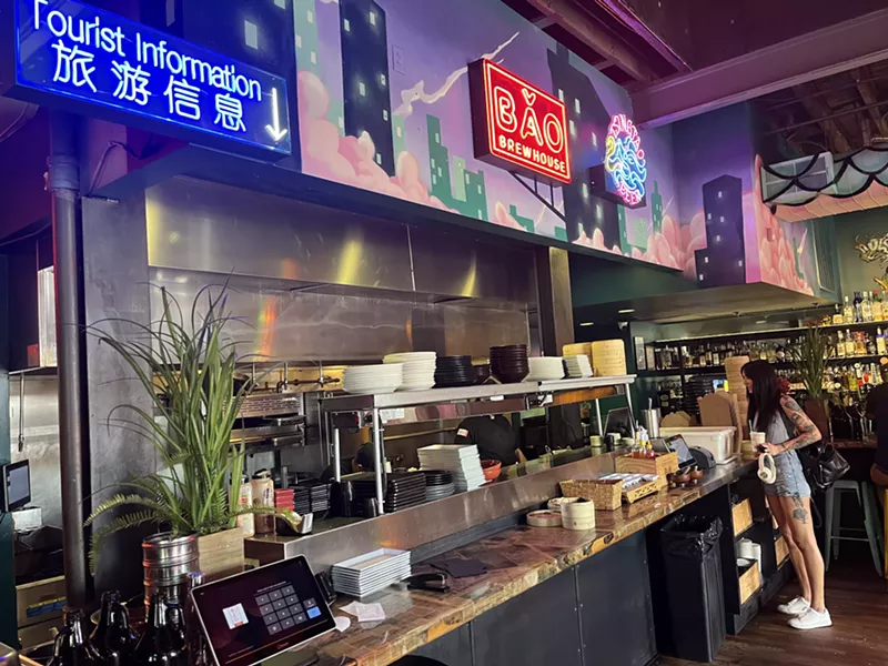 Image: neon signs hanging over a counter at a restaurant