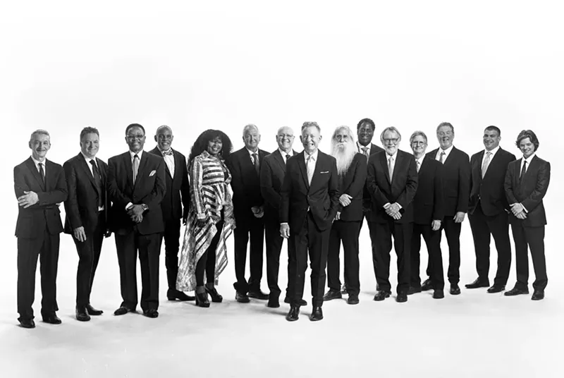 Image: lyle lovett and his large band pose for a photoshoot