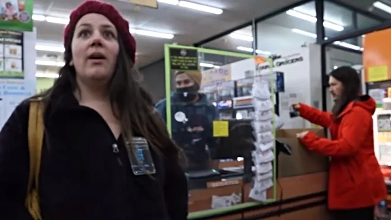 Image: A screen capture from a video showing unmasked shoppers at a Lakewood Natural Grocers store.