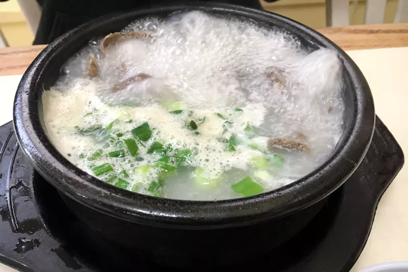Image: A bowl of beef soup called seolleongtang comes to the table at a rolling boil.
