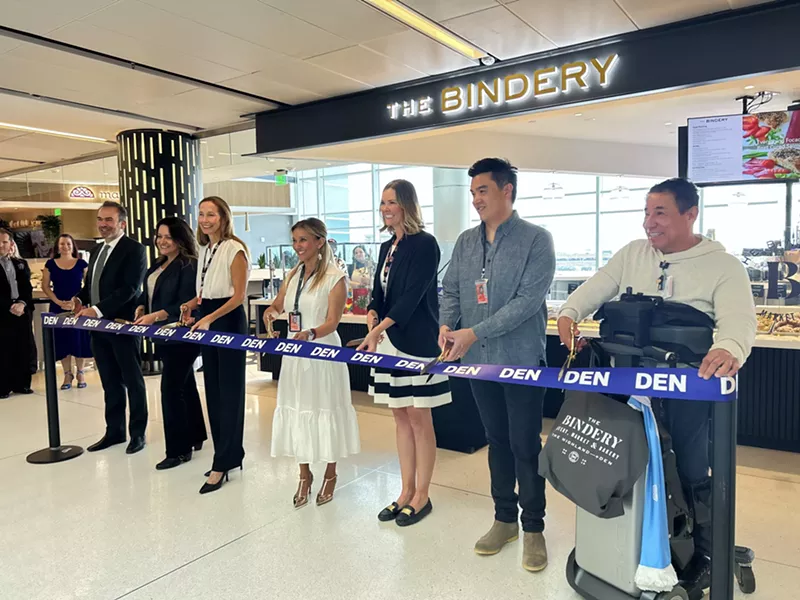 Image: Restaurant owners and airport representatives readying to cut the grand opening ribbon