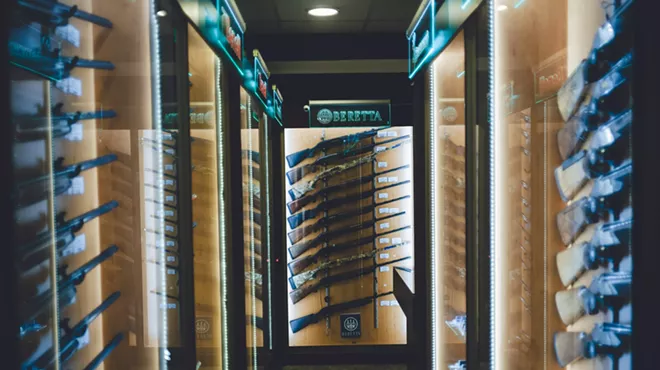 Racks of rifles for sale inside of a gun store