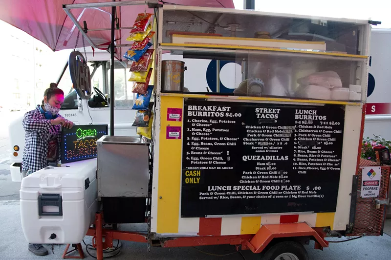 Image: Maria Marquez opens up the family-owned taco stand at 17th Avenue and Blake Street.