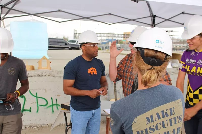 Image: Mayor Hancock dons a hard hat and talks to individuals at a tiny-home village being constructed in RiNo.