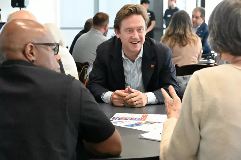 Image: A man smiles.