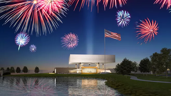 museum with water in front, fireworks behind