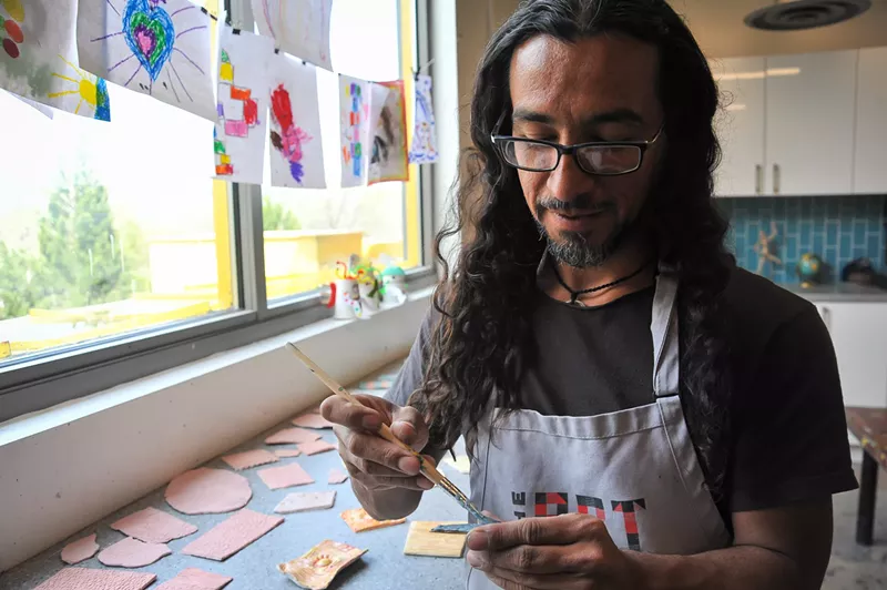 Image: Chilean artist Adolfo Romero makes tiles for a mosaic at the Children's Museum of Denver.