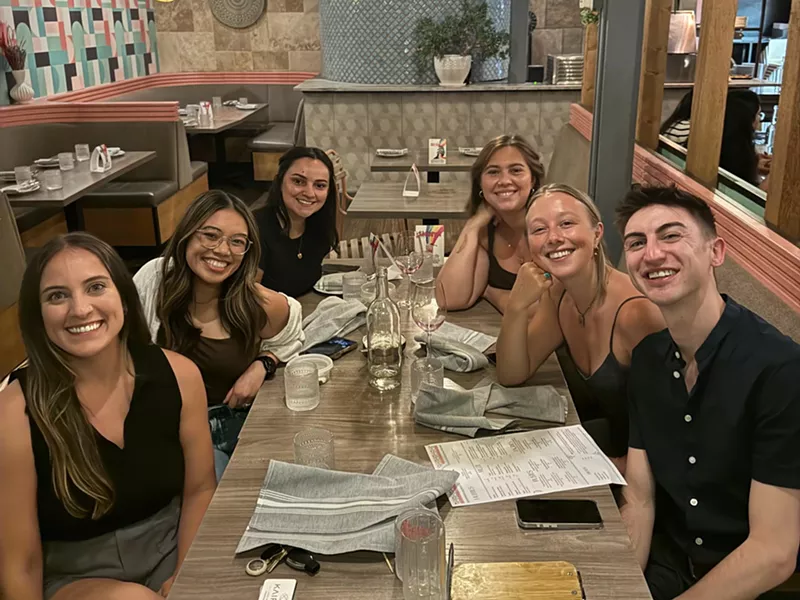 Image: six people at a table in a restaurant
