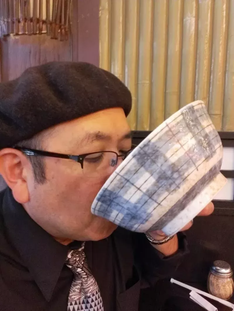 Image: man in beret slurping ramen