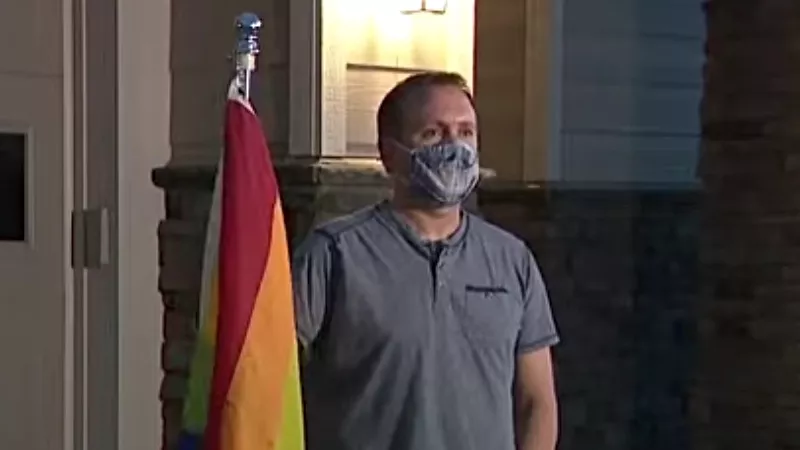 Image: David Pendery in front of his Arapahoe County home with his Pride flag.