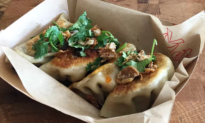 Image: Handmade chicken-and-chive dumplings come doused in a black vinegar and soy sauce.