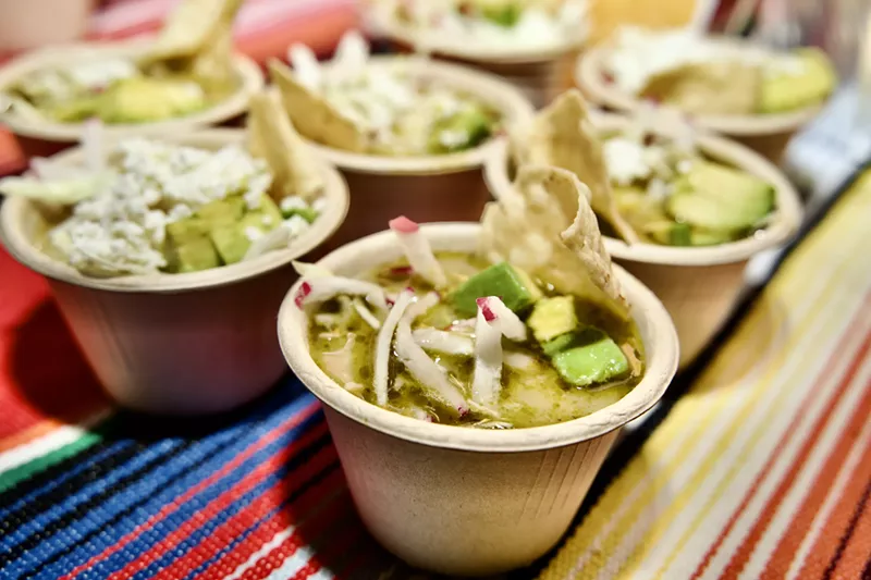 Image: small cups of pozole on a colorful tablecloth