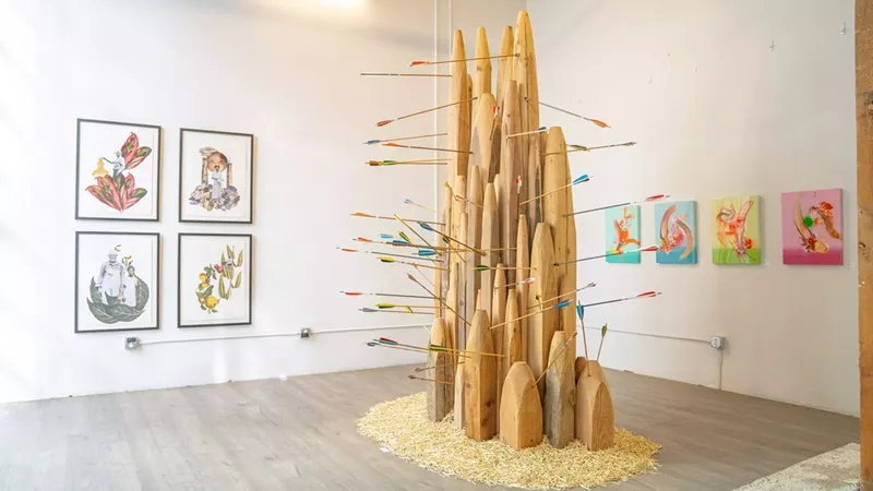Image: Eric Dallimore's "King Me" installation with works on paper by Tya Anthony (left) and Javier Badell's resin paintings (right).