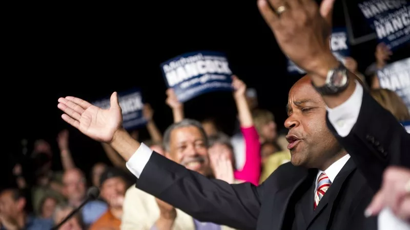 Image: Michael Hancock celebrating his election in June 2011, with former Denver mayor Wellington Webb looking on.