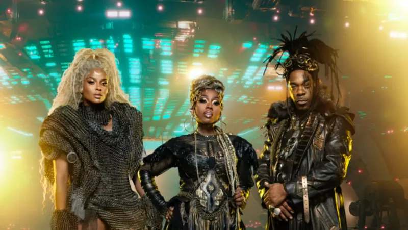 Image: two women and a man in intergalactic outfits