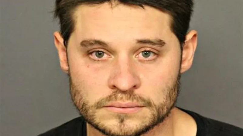 Image: The booking photo of John Affourtit.