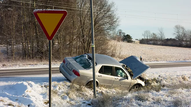 car crashes into snowy hill