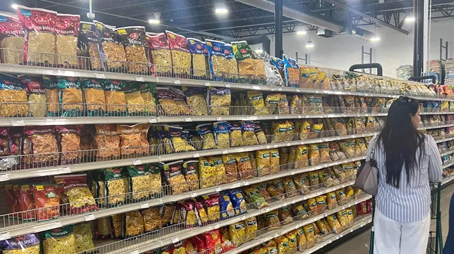 grocery aisle stocked with bags of snacks