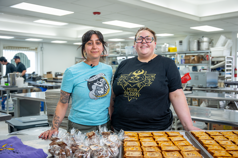 Image: two women posing in front of pastries