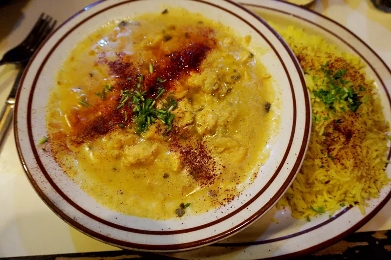 Image: Syrian chicken stew topped with sumac powder.