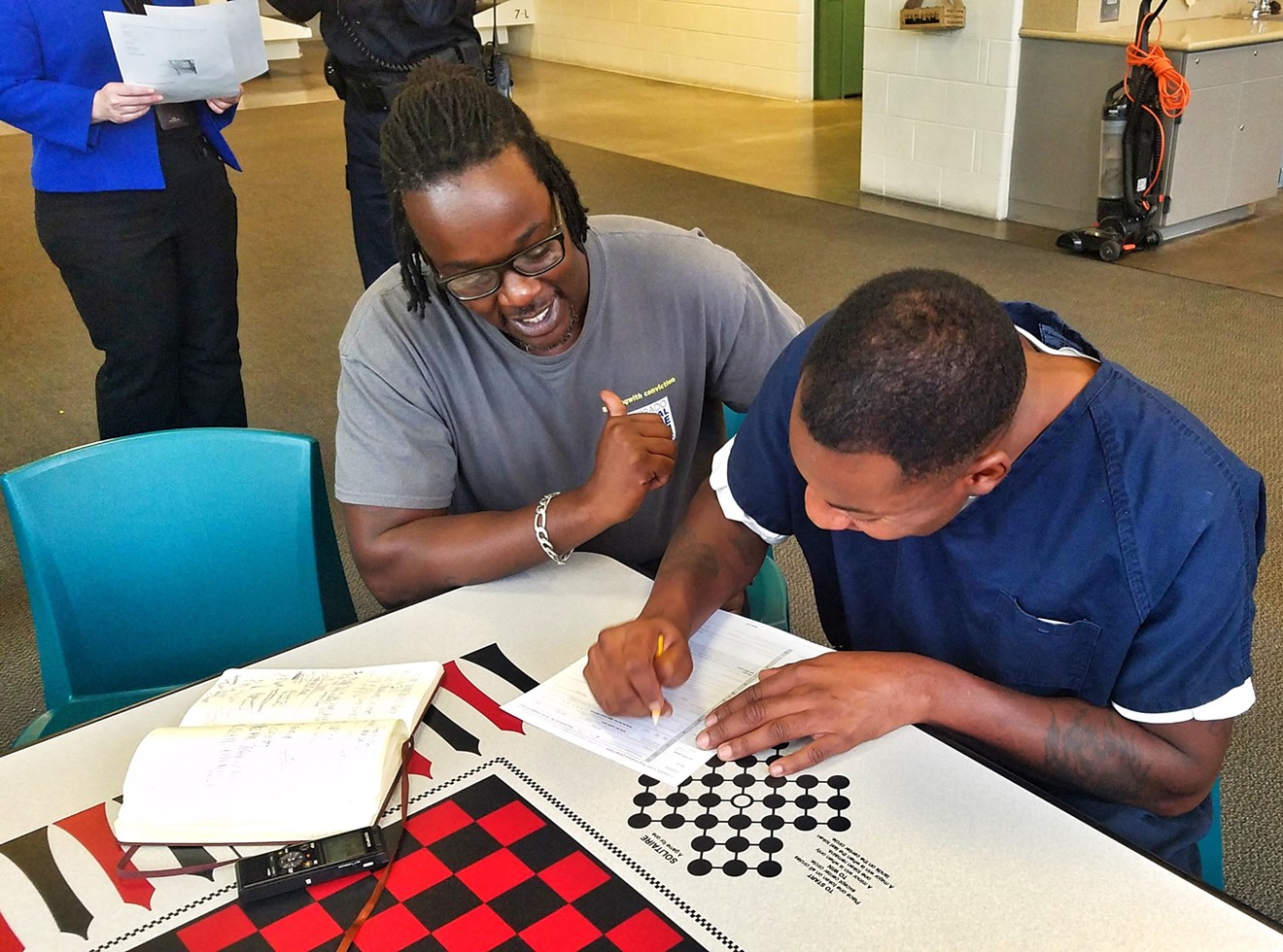 Juston Cooper helps an inmate named Jamayl vote.