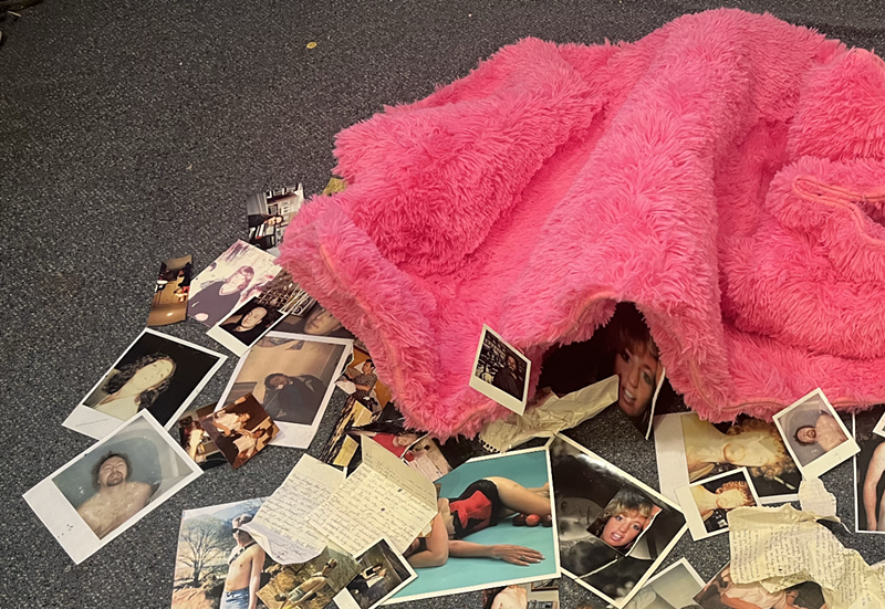 Image: A pink shag rug surrounded by photos and letters