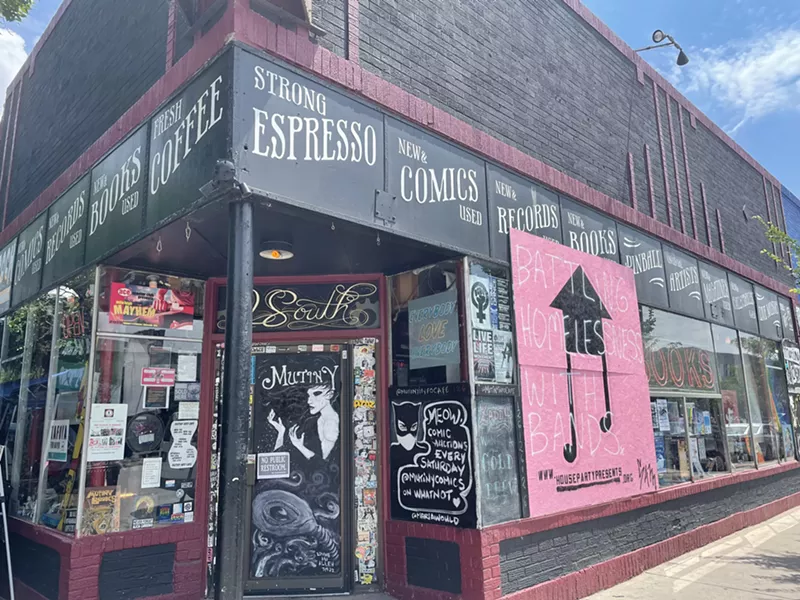 Image: Mutiny Information cafe has a board covering up the smashed in windows.