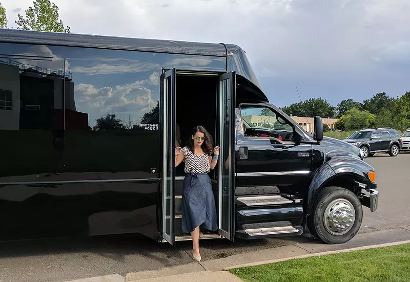 Image: A rider steps off a My 420 Tours bus,