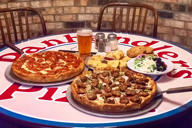 Image: Panhandler's whole pizzas are served thick, round and loaded with toppings.