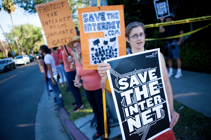 Image: Protesters at a net neutrality rally in July 2014.