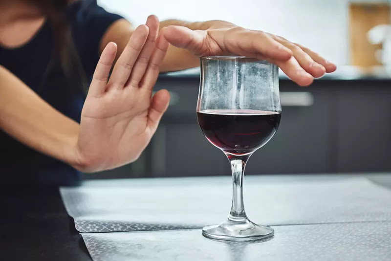 Image: woman refusing wine