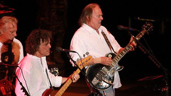 two men in white shirts playing guitar