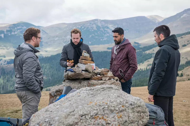 Image: Four British lads played by (from left) Sam Troughton, Rafe Spall, Arsher Ali and Robert James-Collier hike through the deserted woods of northern Sweden before bashing open the door of a decrepit cabin to spend the night there in The Ritual.