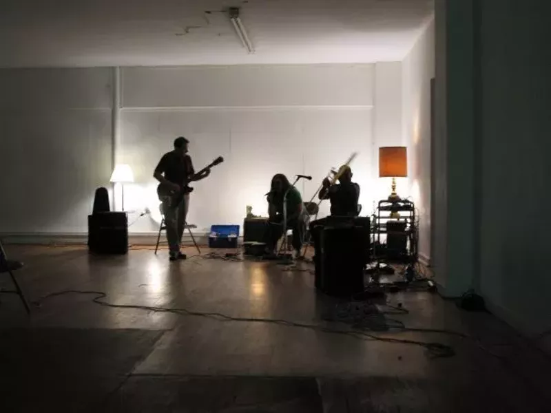 Image: band members practicing in an empty room