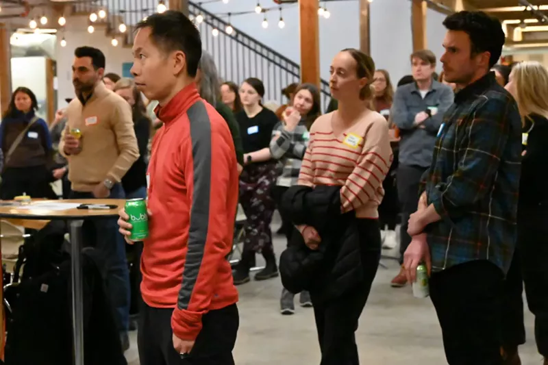 Image: People stand and talk during party