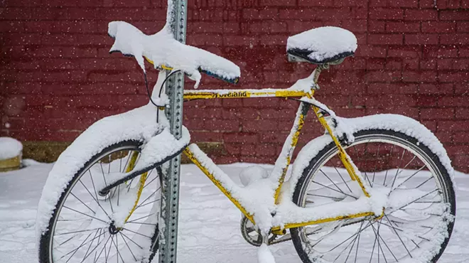 bike covered in snow on street
