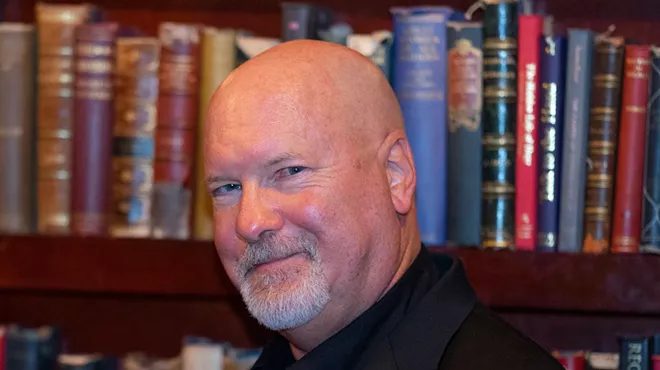 Kevin J. Anderson in front of a bookshelf