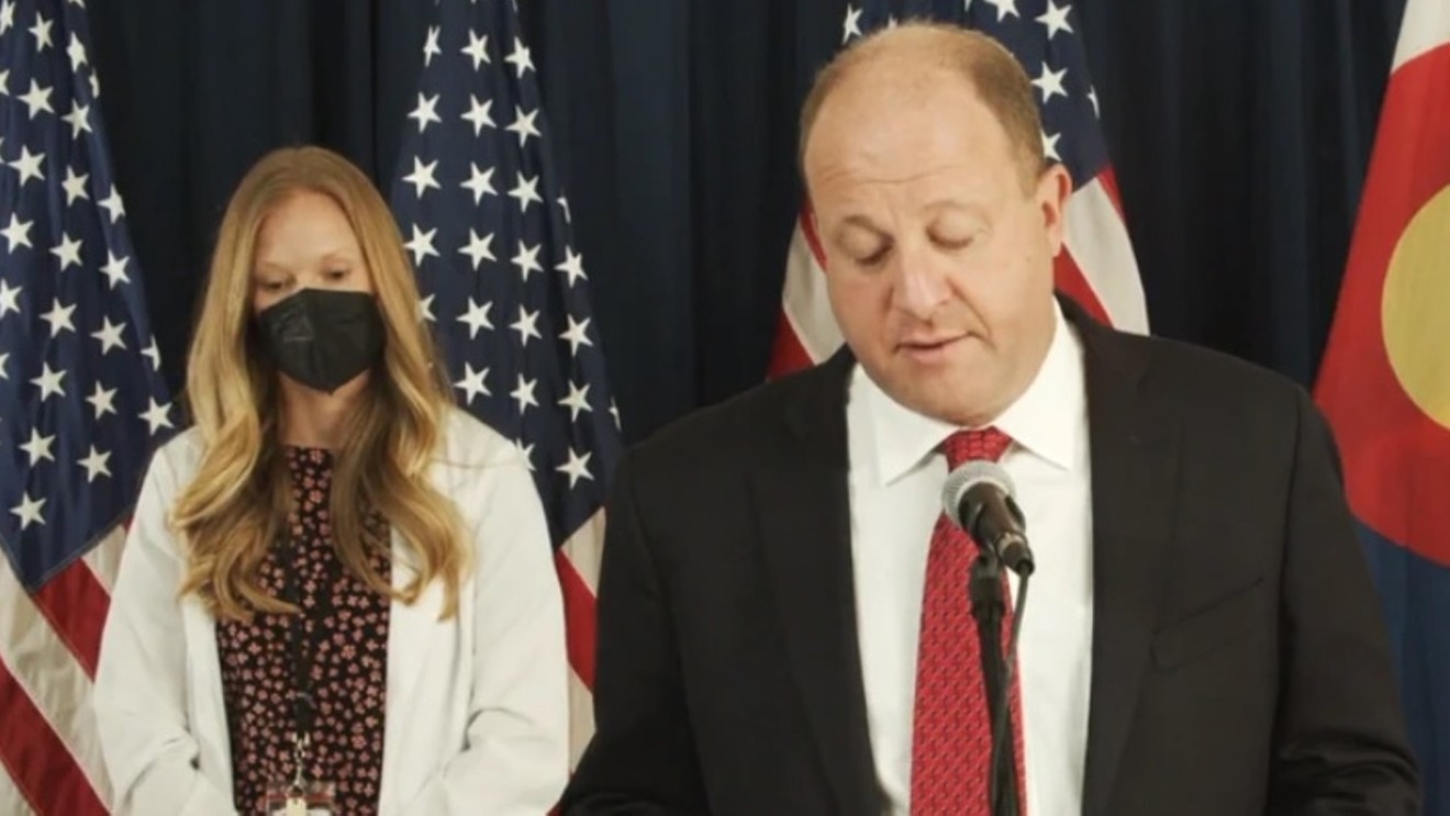 Governor Jared Polis and Colorado lead epidemiologist Rachel Herlihy at a recent press conference.