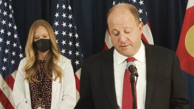 Image: Governor Jared Polis and Colorado lead epidemiologist Rachel Herlihy at a recent press conference.