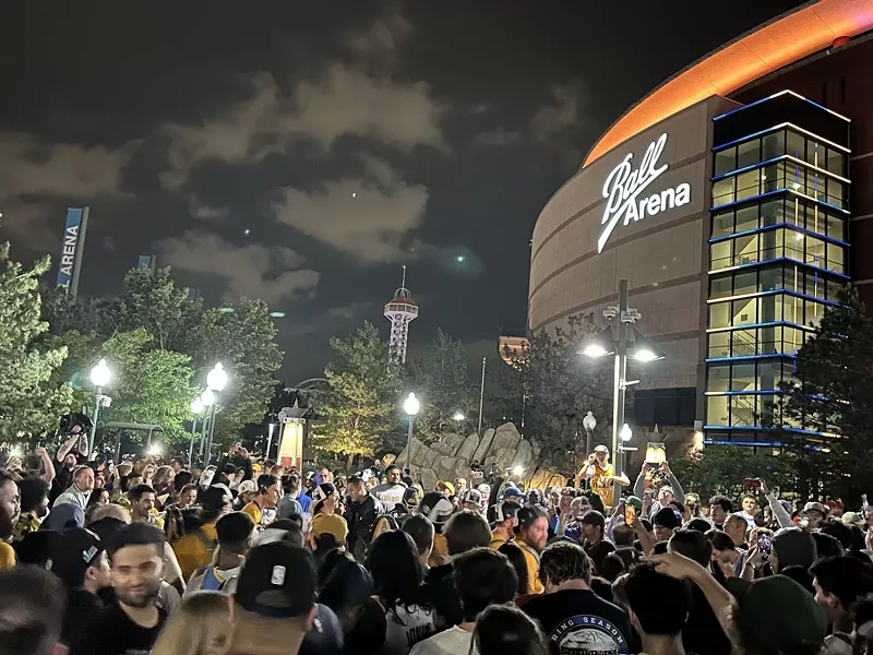 Image: fans celebrating Denver Nuggets win outside Ball Arena.