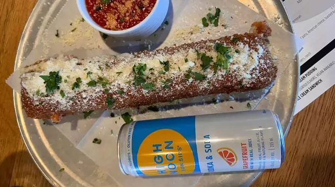 a giant mozzarella stick next to a can of high noon