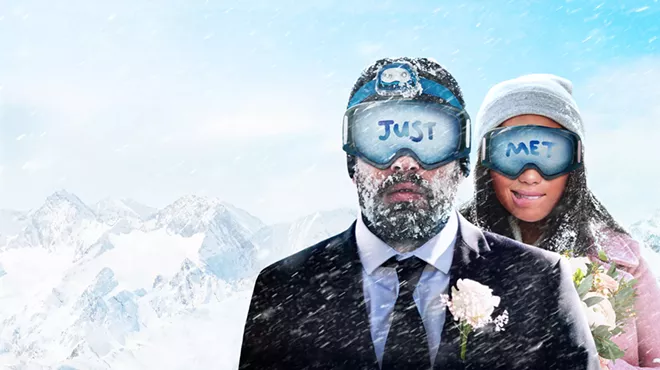 bride and groom in snow and goggles.