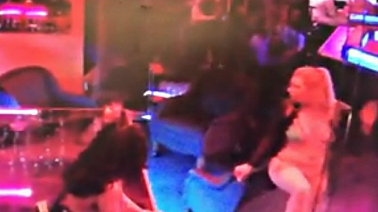 A screen capture from a video showing Randall Wright being tackled by a bartender at Shotgun Willie's on May 2. The pair are in the upper right portion of this image.