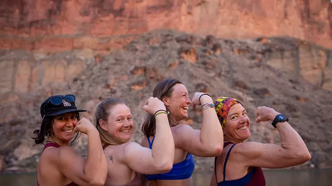 Four women pose together in the Grand Canyon.