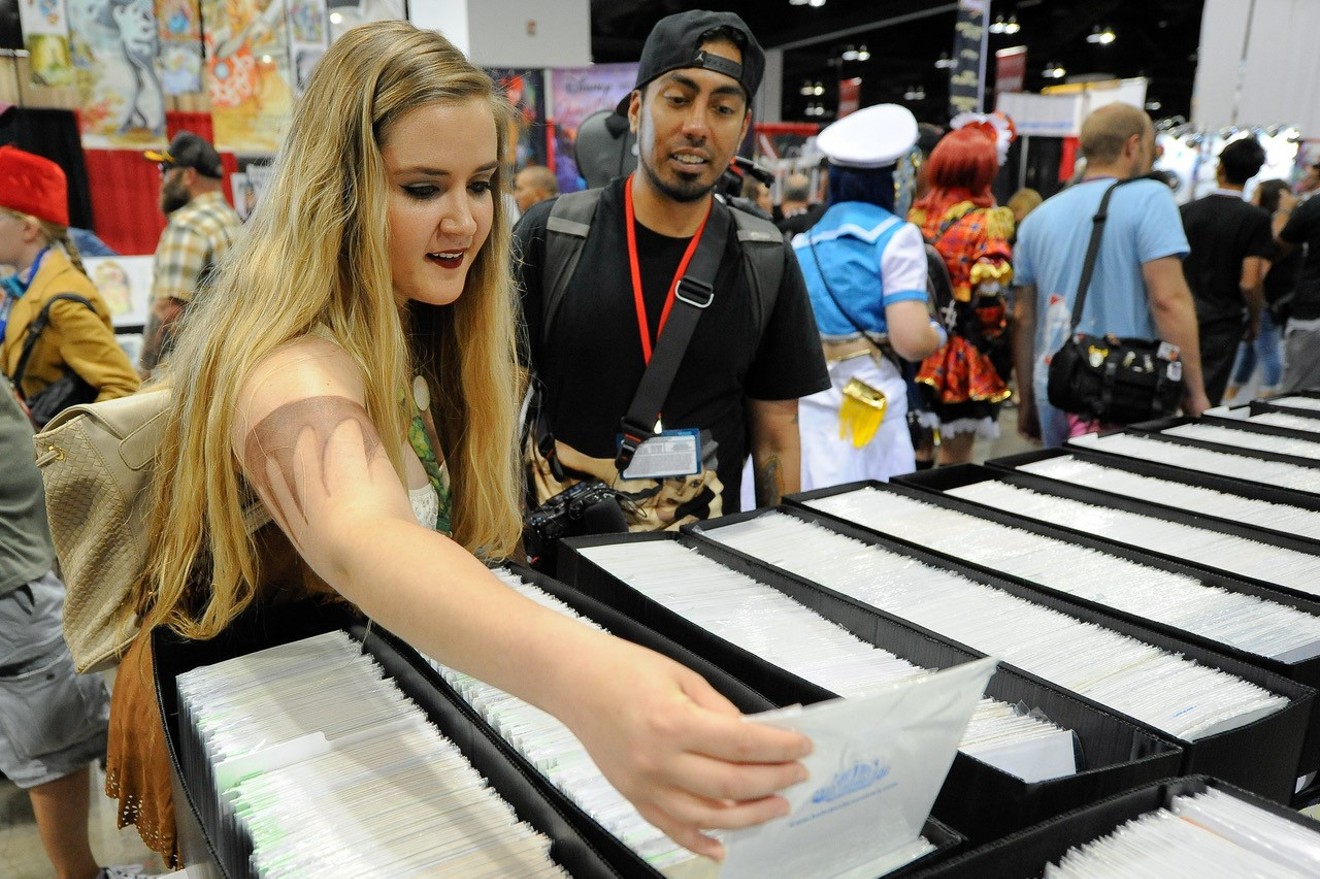 Fans search through comics and more on the convention floor.