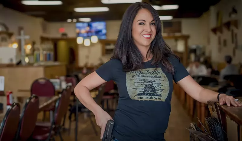 Image: Can a winning smile, a cocked hip and an equally cocked gun win a U.S. Congressional seat?