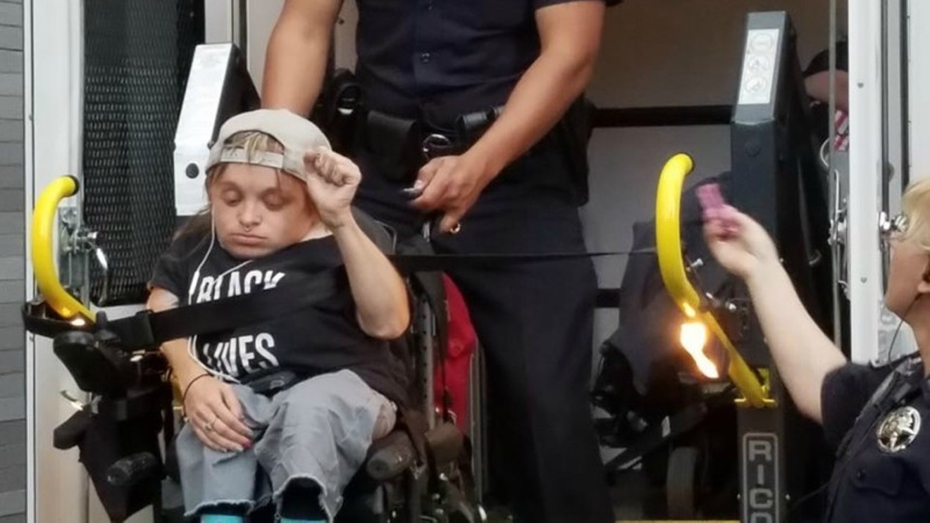 Protester and Wheelchair Sports Camp MC Kalyn Heffernan being taken into custody during a sit-in at Senator Cory Gardner's office on June 29, as seen in a photo from her Facebook page.