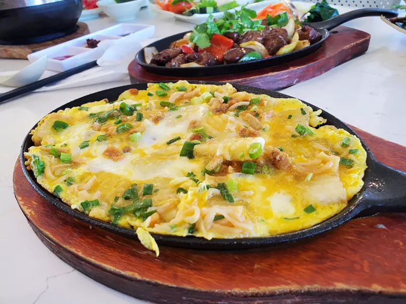 Image: an omelet with rice makes on a skillet